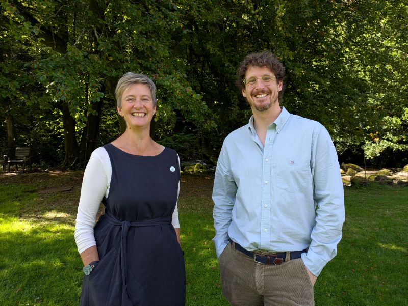 Jenny Isaac stood with new Moor Trees' chair of trustees, Tom Kennard smiling with trees behind